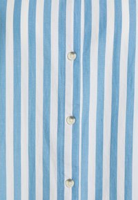 Light blue and white striped shirt made of cotton, featuring a button-up front with small, round buttons and a smooth texture.
