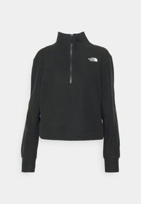 Schwarzer Pullover mit Viertelreißverschluss, ausgestattet mit einem hohen Kragen, langen Ärmeln, gerippten Manschetten und einem kleinen weißen Logo auf der linken Brust.