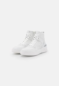 White high-top sneakers made of textured leather, featuring a front lace-up design, side zipper, and a contrasting gray accent on the heel.