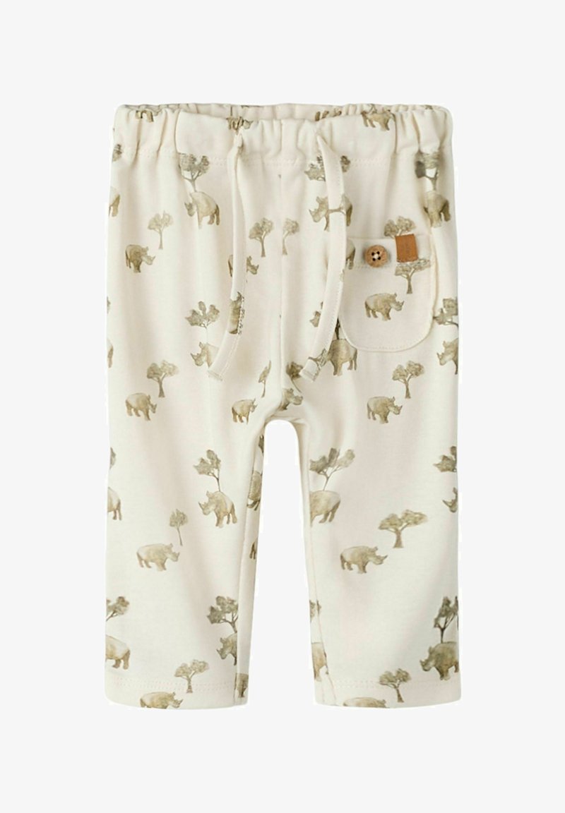 Pantalon pour tout-petit couleur crème avec taille élastique, cordon de serrage, poche avant et impression de rhinocéros et d'arbres dans des tons doux.