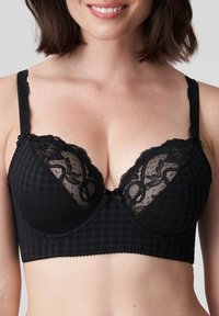 Czarny stanik w kratkę z koronkowym wykończeniem, z fiszbinami, dekoltem w kształcie litery V oraz ozdobnym kokardką na środku.