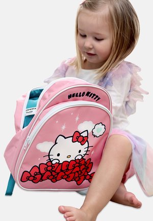 Pink Hello Kitty backpack features a cartoon cat with bows, zip closure, and turquoise interior. Smooth fabric with white accents and graphics.