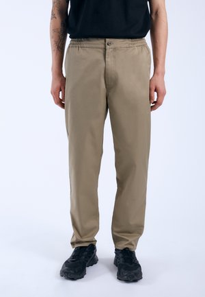 Khaki pants with a slightly tapered fit, featuring an elastic waistband, front button closure, and soft, smooth cotton fabric.