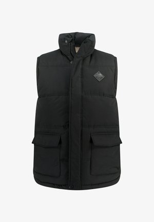 Schwarze gepolsterte Weste mit hohem Kragen, Druckknopfverschlüssen vorne und zwei Brusttaschen. Besitzt ein Diamant-Logopatch auf der linken Seite.