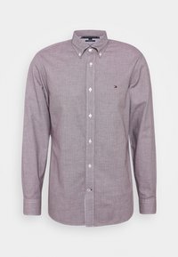 Long-sleeve, button-up shirt in a light purple checkered pattern, made from textured fabric with white buttons and a small logo on the chest.