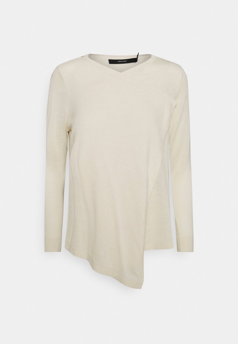 Krémově zbarvený top s dlouhým rukávem s překříženým designem, výstřihem do V a asymetrickým lemem. Měkká textura s pružným materiálem.