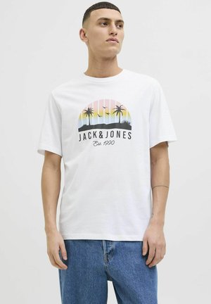 Camiseta de algodón blanca con un gráfico que presenta palmeras y un diseño de atardecer; corte casual, con mangas cortas y escote redondo.