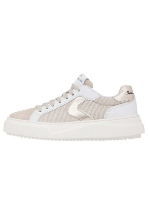 White and beige athletic sneakers with a textured mesh design, smooth leather accents, round laces, and a thick, ridged sole.