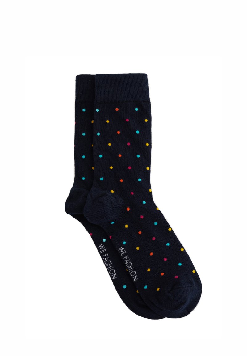 Marina strumpor med flerfärgade prickar. Tillverkade av mjukt material, med ribbad mudd och förstärkt tå för hållbarhet.