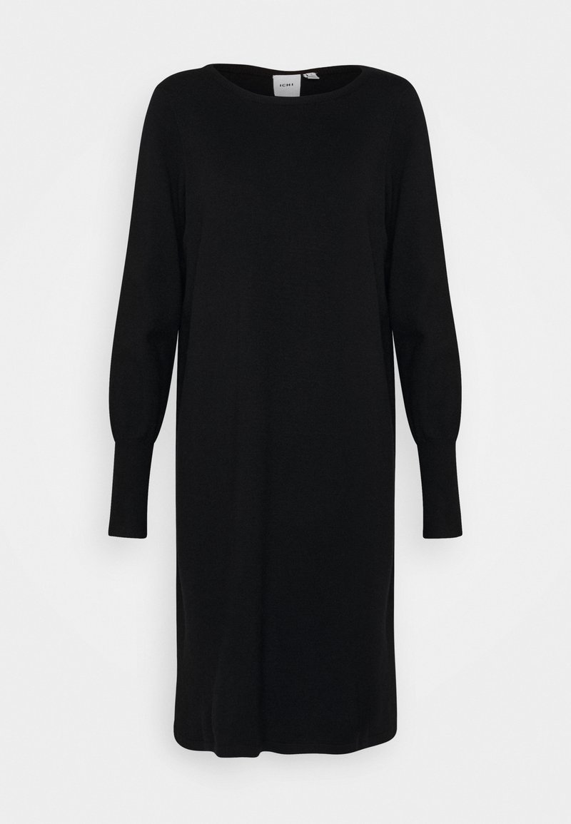 Robe en maille noire à manches longues, longueur genou, avec un col rond et des poignets ajustés, présentée sur un fond blanc uni.