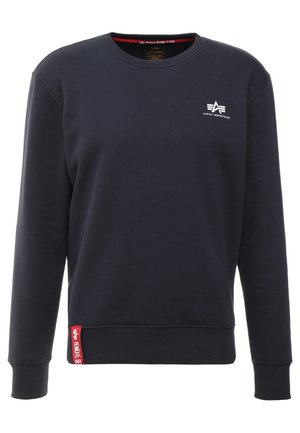 Navy sweatshirt made of soft material with a crew neck, ribbed cuffs and hem, featuring a white logo on the chest and a red label on the side.