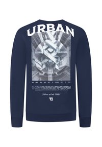 Marineblauwe sweatshirt met grote achterafdruk van een abstracte stedelijke betonstructuur, tekst "URBAN," en een kleinere natuurthema zin eronder.