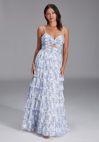 Long floral dress dengan ruffles berlapis, menampilkan pola biru dan putih, bodice yang pas dengan detail twist, dan tali tipis yang bisa disesuaikan.