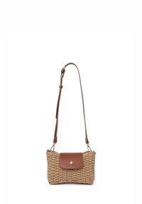 Woven straw crossbody bag in beige with a brown leather flap and button closure. Adjustable strap with gold hardware accents.