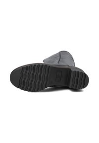 Black ankle boot with a rounded toe, smooth leather upper, and textured rubber outsole featuring horizontal ridges for traction.
