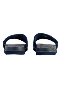 Navy blue sandals with a textured fabric upper and a solid rubber sole, featuring dual straps and a flat design.