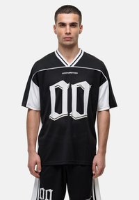 Zwarte mesh jersey met witte accenten en een groot wit "00" gedrukt op de voorkant. Het heeft korte mouwen en een v-halsontwerp.