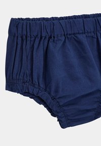 Tumesinised puuvillased bloomers-shorts, millel on kogutud vöökoht ja külgõmblused, pehme tekstuur ja elastsed servad mugavuseks.
