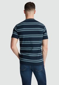 Navy blue striped T-shirt featuring light blue and white horizontal stripes, short sleeves, and a crew neckline, made from soft fabric.
