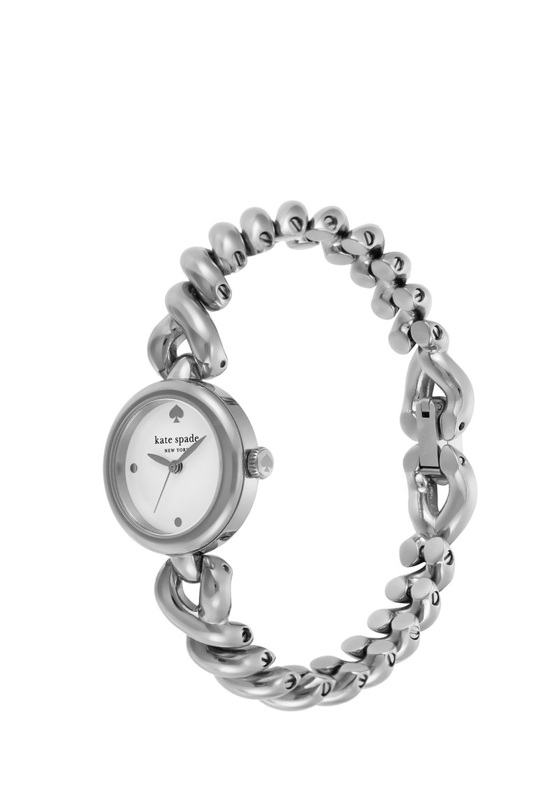 Kellot hopeasävyisellä runolla, jossa on näyttävä ketjumallinen ranneke ja pyöreä valkoinen kellotaulu. Ominaisuuksiin kuuluu minimalistiset tuntimerkit ja kruunu ajan säätämiseksi.