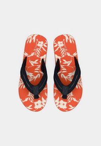 Pair of orange flip-flops with white floral pattern and black fabric straps, displayed on a plain white background.