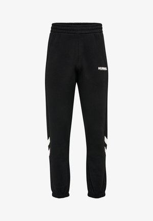 Pantalon de survêtement noir Hummel avec taille et poignets élastiques, bandes blanches en chevron sur les jambes et petit logo blanc Hummel sur la cuisse droite.