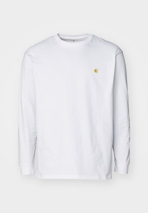 Camiseta de manga larga blanca de algodón. Cuenta con un pequeño logo dorado en el pecho y un cuello redondo. Diseño simple y corte estándar.