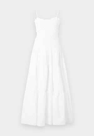 Vestido largo blanco sin mangas con cuerpo fruncido, bordes con volantes, falda de varios vuelos y tirantes delgados.