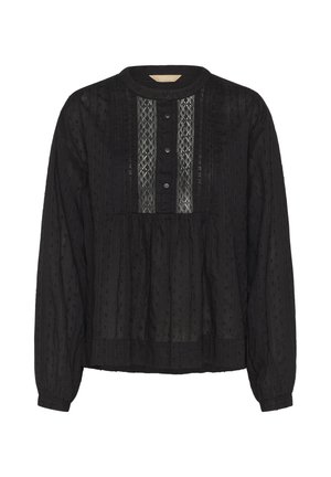 Blouse noire à manches longues avec col rond, patte de boutonnage sur le devant, détails de panneaux en dentelle et motif en tissu à pois texturé.