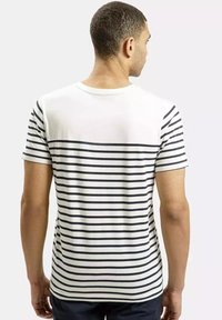 T-shirt z krótkim rękawem w kolorze białym z niebieskimi poziomymi paskami. Materiał bawełniany, okrągły dekolt, luźny krój, widoczne szwy i gładka textura.