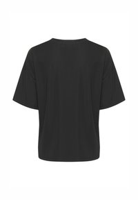T-shirt noir oversize avec des manches courtes, un col rond et un tissu doux. Texture lisse, design minimal et sans motifs ni accents visibles.