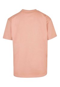 Kortærmet t-shirt i blødt lyserødt bomuld, med rund hals og afslappet pasform, glat tekstur og ren søm.