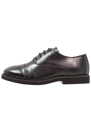 Black leather men's oxford shoe with cap toe, lace-up closure, and low heel, shown in side profile on white background.