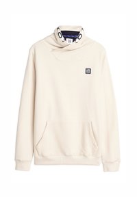 Hoodie couleur crème avec un col bénitier, une poche kangourou et un petit écusson. Tissu doux avec des poignets et un ourlet côtelés.