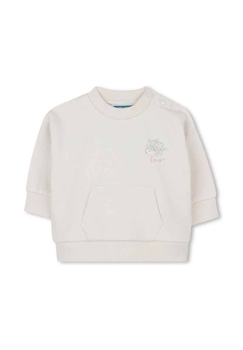 Sweatshirt de couleur crème clair, à manches courtes, avec un col côtelé et une poche. Présente un design brodé et le mot "lengua" en script. Texture de tissu douce.