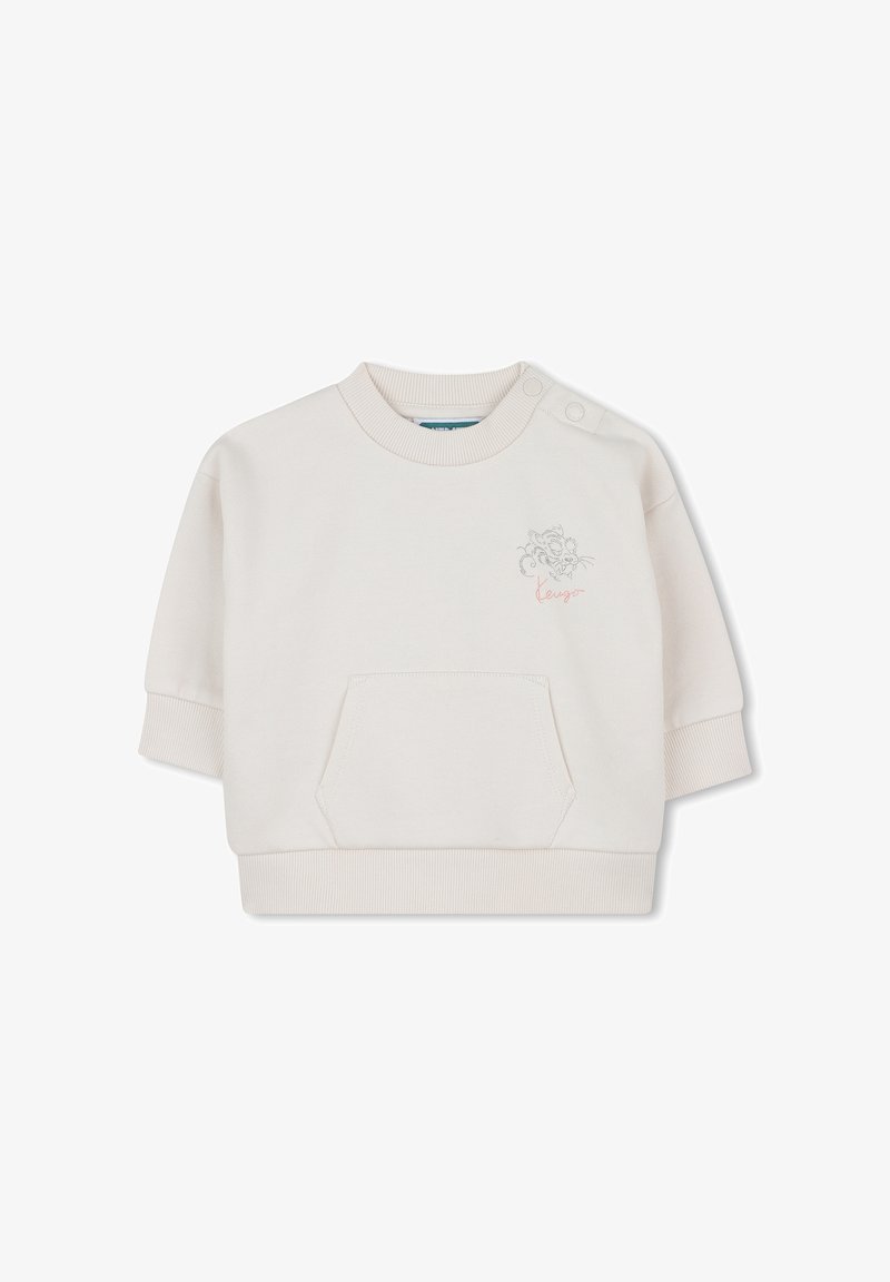 Sweatshirt de couleur crème clair, à manches courtes, avec un col côtelé et une poche. Présente un design brodé et le mot "lengua" en script. Texture de tissu douce.