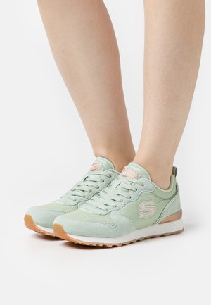 Light green athletic shoes with a mix of mesh and suede materials. Features a padded collar, textured upper, and rubber outsole.