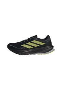 Black and yellow Adidas running shoe with Gore-Tex material, cushioned sole, and three yellow stripes on the side.