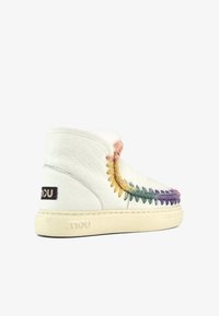 Botas de tobillo blancas de cuero con costuras multicolores y un suave forro de piel. Cuentan con una suela de goma y una etiqueta de logo en el lateral.