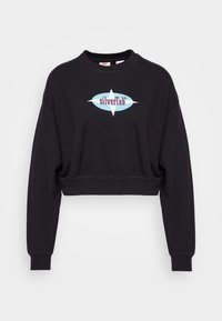 Felpa nera tagliata in cotone, con un logo grafico blu e bordeaux. Maniche lunghe con polsini a costine e scollatura a girocollo.