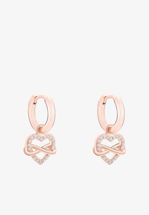 Roségoldene Creolen mit einem filigranen Herzdesign, verziert mit funkelnden klaren Steinen entlang der Kontur, die ein strukturiertes Erscheinungsbild erzeugen.