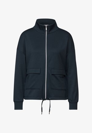 Veste à zip bleu foncé avec un col montant, deux poches avant, des poignets élastiques et un ourlet ajustable. Fabriquée en tissu doux et respirant.