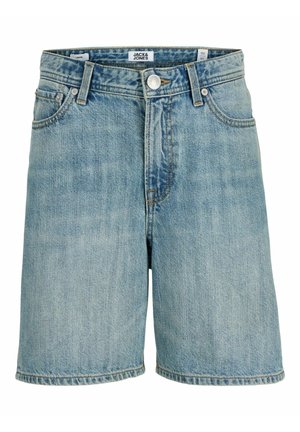 Dječak odjeven u svijetloroza majicu, traper kratke hlače, bijele čarape, bijele tenisice i svijetloplatu kapu, gleda prema desno.