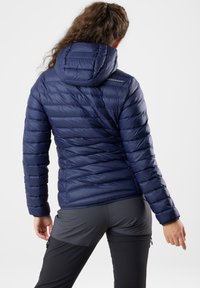 Navy blue insulated jacket with horizontal quilted pattern and a hood. Lightweight material with shiny finish and subtle logo detail on the shoulder.