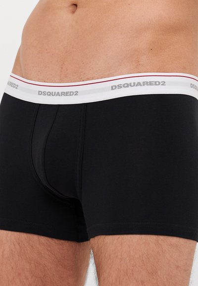 Black cotton boxer briefs with a white waistband featuring "DSQUARED2" logo in gray, accented by a red stripe. Fitted shape, smooth texture.