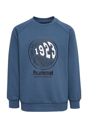 Blauwe trui met geribbelde halslijn en manchetten. Heeft een zwart-wit grafisch ontwerp van een basketbal en de tekst "1923" en "hummel SPORTSWEAR."