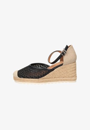 Scarpa espadrillas con zeppa, punta in rete nera, tacco intrecciato beige, cinturino alla caviglia con fibbia e suola platform in juta intrecciata.