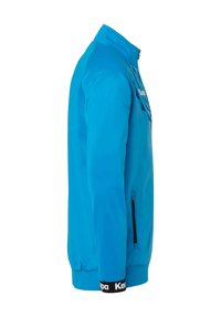 Blå sportsjakke med høj krave, lynlåslukning, sidelommer og kontrastfulde sorte manchetter med hvid tekst. Lavet af glat, letvægtsstof.