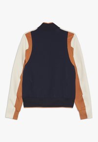 Navy, orange, and cream color-blocked sweatshirt with a high collar and ribbed cuffs. Smooth texture, athletic fit, and side pockets.