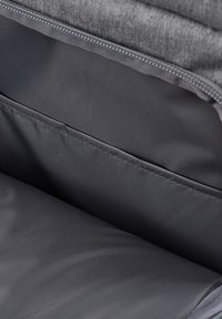 Gray fabric zipper closure, revealing a smooth black interior lining with a simple, spacious design and clean stitching detail.